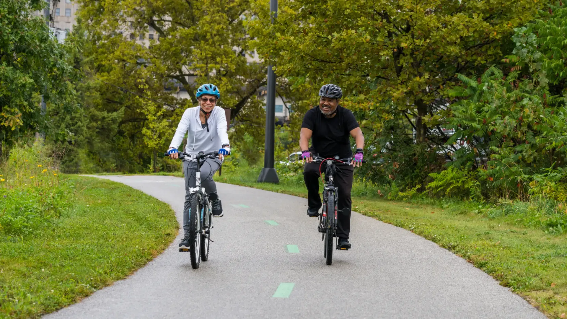 TwoPeopleBikingDownPath