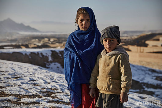Seven-year-old Farhanaz* and her brother Najeebullah*, 5, near their home in Kabul. They fled their home in Nangarhar province three years ago.