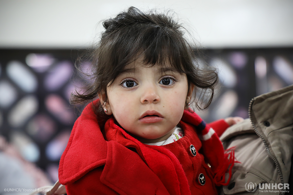 3 year-old Serin prepares with her family to cross the border back home to Syria.